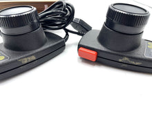 Load image into Gallery viewer, Atari VCS 2600 Woody console close-up of black gaming controllers with ergonomic design.