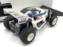 Load image into Gallery viewer, Underside view of the remote control car showing chassis details.