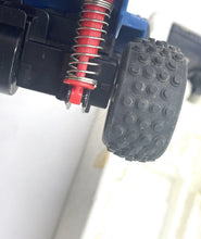 Load image into Gallery viewer, Detail of car wheel showcasing textured tire and suspension detail.