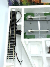 Load image into Gallery viewer, Detail of Lima train tracks showing straight tracks and included accessories.
