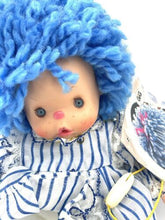 Carica l'immagine nel visualizzatore di Gallery, Close-up detail of the Patapouf New Girl doll's face featuring big eyes and blue hair.