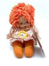 Load image into Gallery viewer, Patapouf New Girl doll front view with orange curly hair and patterned dress.