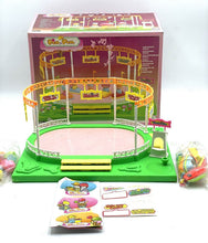 Load image into Gallery viewer, Famosa carousel toy packaging displaying colorful figures in pink, yellow, and green.