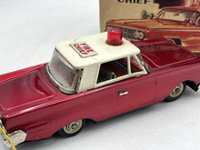 Load image into Gallery viewer, Detail view of the red vintage car highlighting chrome details.