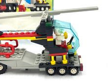 Load image into Gallery viewer, Detail view of the red LEGO helicopter with transparent cockpit and rotor blades.