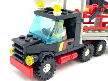 Load image into Gallery viewer, Close-up detail of the black and red LEGO truck featuring transparent windows and yellow lights.