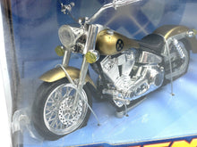 Load image into Gallery viewer, Close-up detail of the gold and silver motorcycle with chrome finish and detailed wheels.