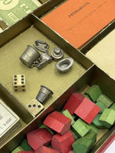 Load image into Gallery viewer, Monopoli Italiana 1937 game box interior featuring cards and game pieces.