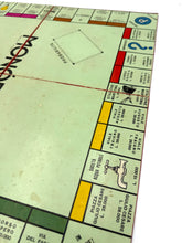 Load image into Gallery viewer, Side view of the Monopoli game board highlighting property spaces and design.
