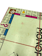 Load image into Gallery viewer, Side view of the Monopoli game board displaying classic layout and empty spaces.