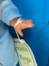 Load image into Gallery viewer, Detail of Tino Ride's hand holding a bag, showcasing intricate features.