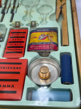Load image into Gallery viewer, Close-up detail of science kit parts featuring metal components and labels.