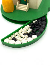 Load image into Gallery viewer, Detail close-up of the green base with various colored toy pieces