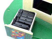 Load image into Gallery viewer, Close-up of a drawer containing multiple black toys.