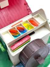 Load image into Gallery viewer, Art supplies box with colorful compartments and various supplies in red, green, blue, and yellow.