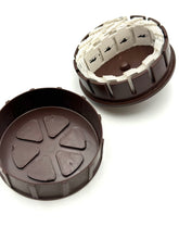 Load image into Gallery viewer, Detail of chocolate mold featuring two decorative brown and cream pieces on a white background.
