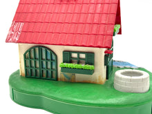 Load image into Gallery viewer, Side view of the toy windmill house showing the green base