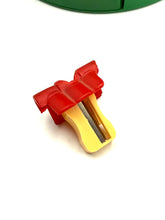 Load image into Gallery viewer, Il Mulino degli Artisti toy piece close-up showing red and yellow sharpener on a white background.