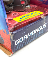 Load image into Gallery viewer, Packaging view of Gormongus toy showing brand logo and warning label.