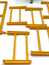 Carica l'immagine nel visualizzatore di Gallery, Mattel Sunshine Family Farm detail close-up of yellow painting tools featuring a paint tray with various shapes.