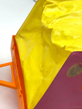 Load image into Gallery viewer, Detail view of a folded yellow and orange bag with a colorful design.