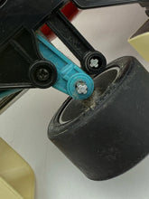 Load image into Gallery viewer, Detail close-up of the black toy car highlighting mounting points and visible wheels.
