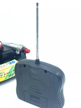 Load image into Gallery viewer, Back view of the remote control showing the antenna and battery compartment.