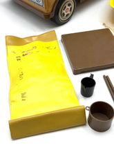 Load image into Gallery viewer, Detail view of the camper and accessories spread out on a surface