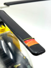 Load image into Gallery viewer, Detail of the black and yellow part featuring a red label on the helicopter.