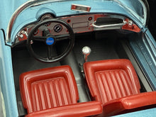 Load image into Gallery viewer, Close-up detail of the blue model car interior showing steering wheel and seats.