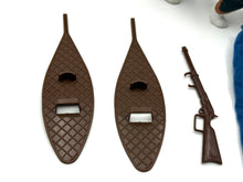 Load image into Gallery viewer, Detail close-up of two snowshoes and a toy rifle from the playset.