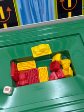 Carica l'immagine nel visualizzatore di Gallery, Detail shot of various colored game pieces on the Frogger game board