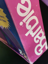 Carica l'immagine nel visualizzatore di Gallery, Detail close-up of Barbie packaging showcasing colorful design and text logo.