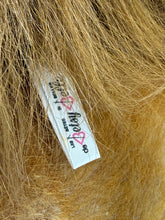 Load image into Gallery viewer, Detail close-up of label on Betsy Belle plush lion's fur.