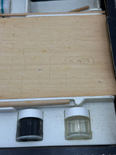 Carica l'immagine nel visualizzatore di Gallery, Close-up of the contents inside the Prosolar model kit box showing jars on a wooden surface.