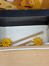 Carica l'immagine nel visualizzatore di Gallery, Detail view of craft tools from the Prosolar kit including yellow gears and a wooden stick.