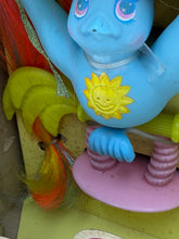Carica l'immagine nel visualizzatore di Gallery, Detail view of the Blue Bird figure displaying a playful expression and sun design.