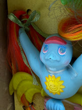 Carica l'immagine nel visualizzatore di Gallery, Blue plush toy with a smiling face and sun design, arms raised.