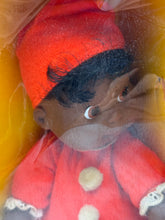 Load image into Gallery viewer, Close-up detail of the African American doll's face, showcasing its features and cap.