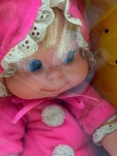 Load image into Gallery viewer, Close-up detail of the doll's smiling face with blue eyes.