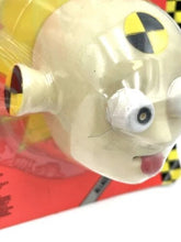 Carica l'immagine nel visualizzatore di Gallery, Detail close-up of Tyco crash test dummy toy with cartoonish design and safety markings