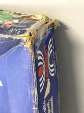 Load image into Gallery viewer, Detail of the game box edge showing damage and graphic design.