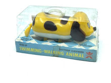 Load image into Gallery viewer, Bandai Wind-up Swimming and Walking Dog in transparent packaging, showcasing the yellow toy dog.