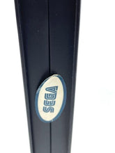 Load image into Gallery viewer, Close-up detail of the Sega logo in blue and white oval shape.