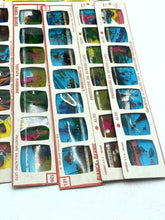 Load image into Gallery viewer, Detail close-up of sticker sheets with various images in blue, yellow, and red.
