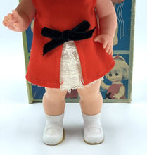 Load image into Gallery viewer, Front view of the 1967 Mattel Walk n Play doll wearing a red dress and black bow.