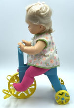 Load image into Gallery viewer, Detail close-up of the Mattel Tippee Toes doll's arm showing dress detail and tricycle handle.
