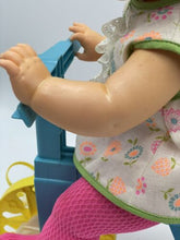 Load image into Gallery viewer, Side view of the Mattel Tippee Toes doll on a tricycle, wearing a dress.