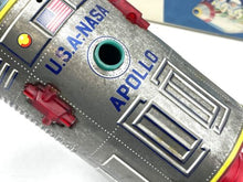 Load image into Gallery viewer, Close-up of the dome-shaped top of the vintage battery-operated space capsule toy with decorative elements.