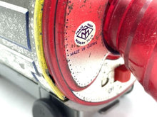 Load image into Gallery viewer, Close-up of the red metallic lens on the vintage battery-operated space capsule toy.